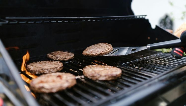 Flipping burgers on a grill