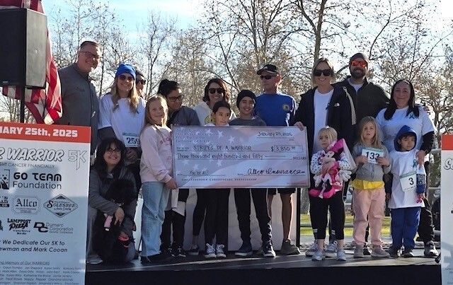Group photo of Allco team delivering donation check to Stripes of a Warrior foundation