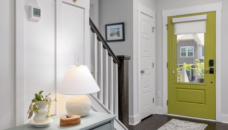 Modern home entryway with green front door