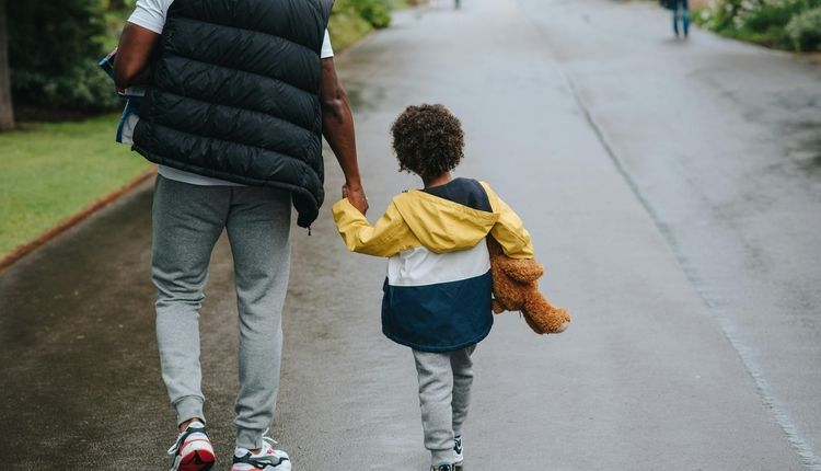 Father and son walking down the street