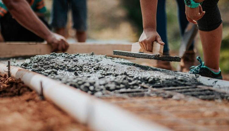 Leveling wet concrete at a construction site