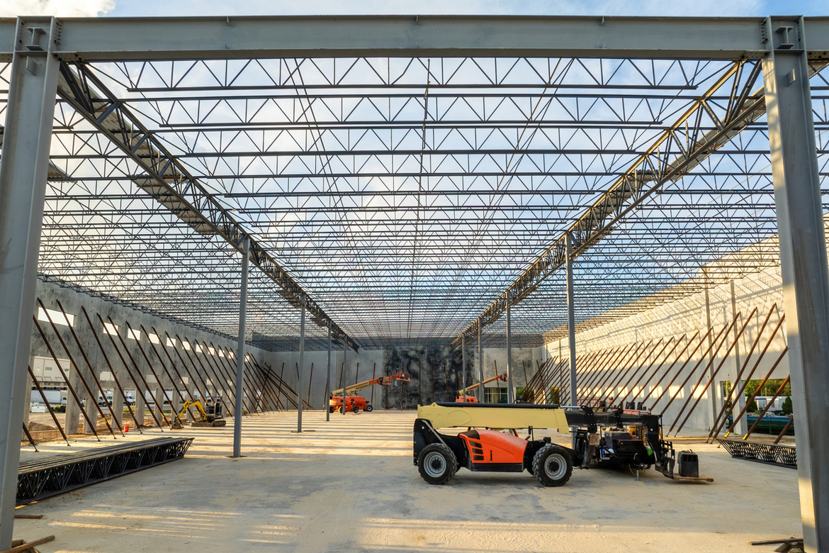 A warehouse construction site with heavy equipment