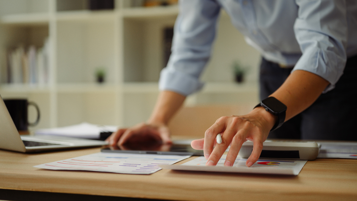 A consultant reviews documents at desk