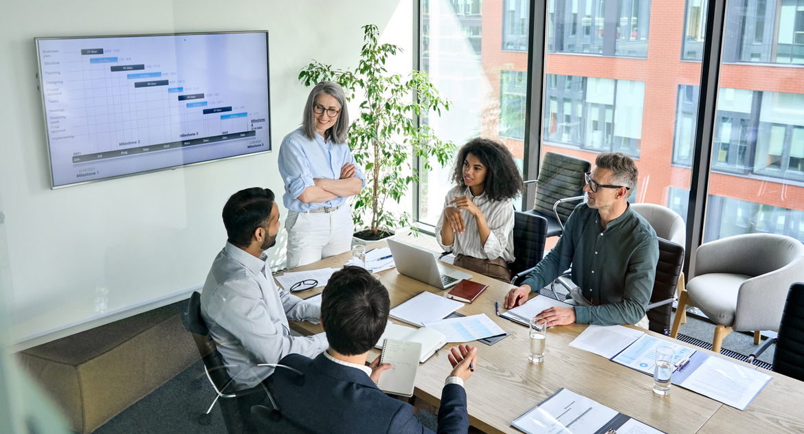 A professional services firm discusses business growth in a conference room, representing growing liability