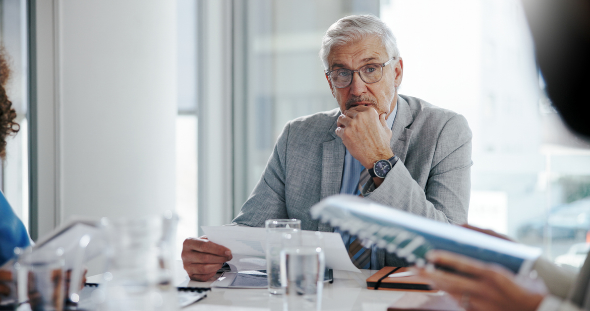 Business executive reviewing agreement for protection against technology mistakes
