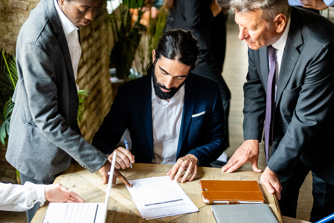 Startup founder and investors reviewing a term sheet