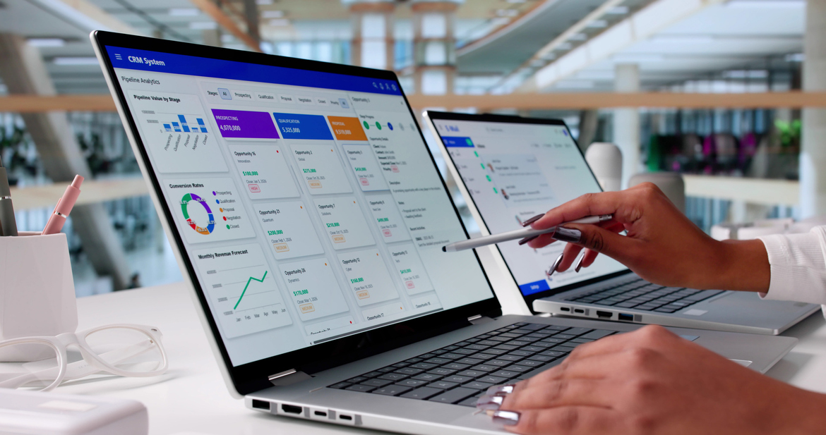Female SaaS business leader points to a laptop with a pen